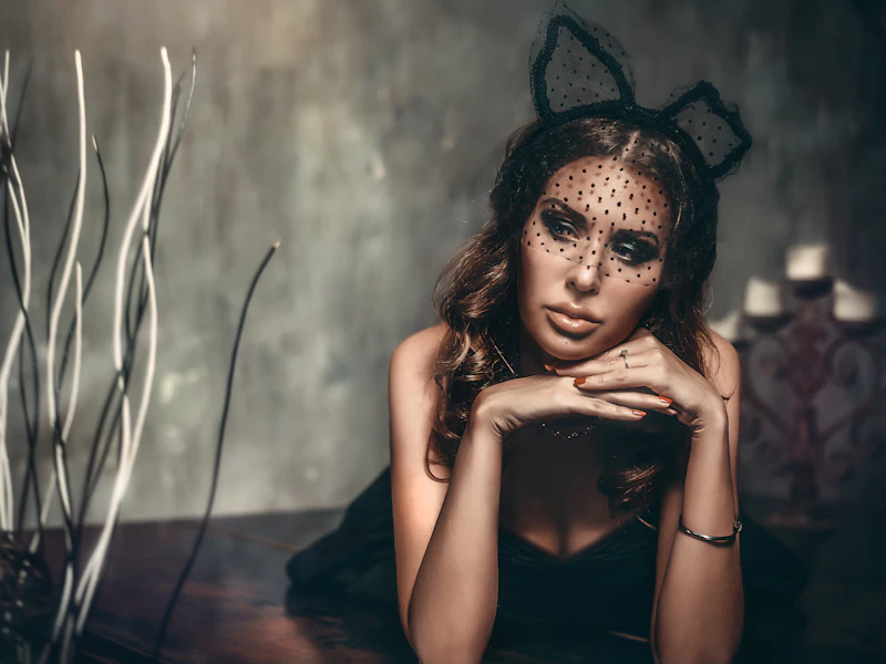 Woman wearing black cat ears and cat makeup for Halloween