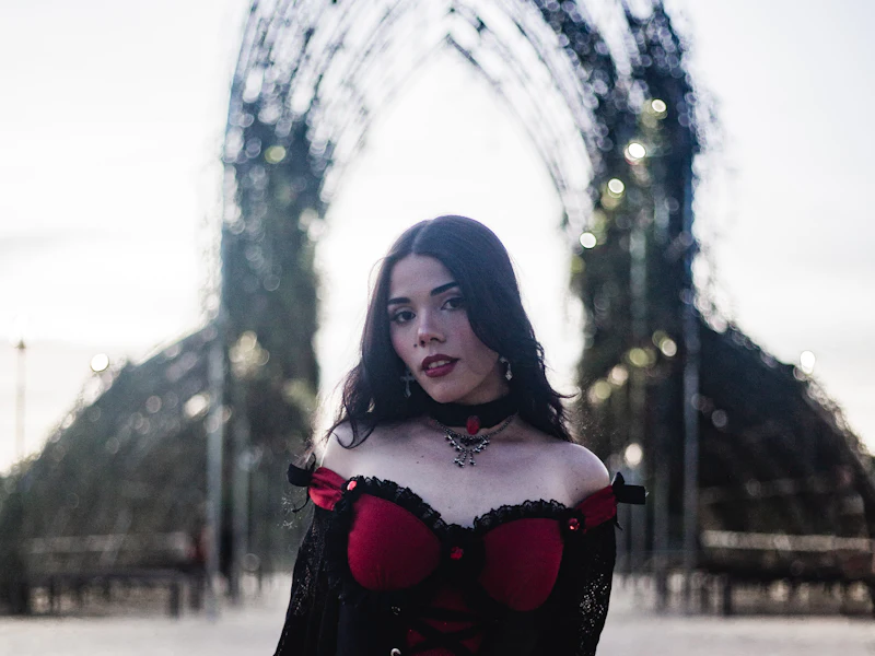 Woman in a gothic vampire Halloween costume with a red corset